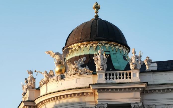 Hofburg Palace dome with ornate sculptures, Vienna, Austria.