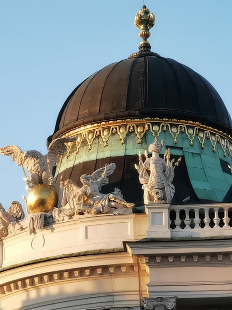 Hofburg Palace dome with ornate sculptures, Vienna, Austria.