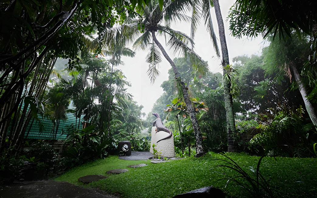 Tropical garden with reptile statue at Bali Reptile Park.