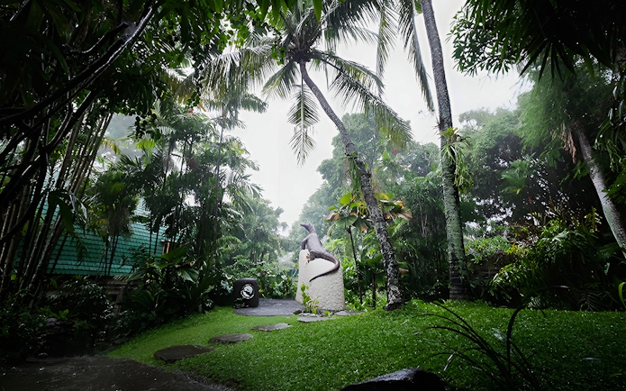 Tropical garden with reptile statue at Bali Reptile Park.