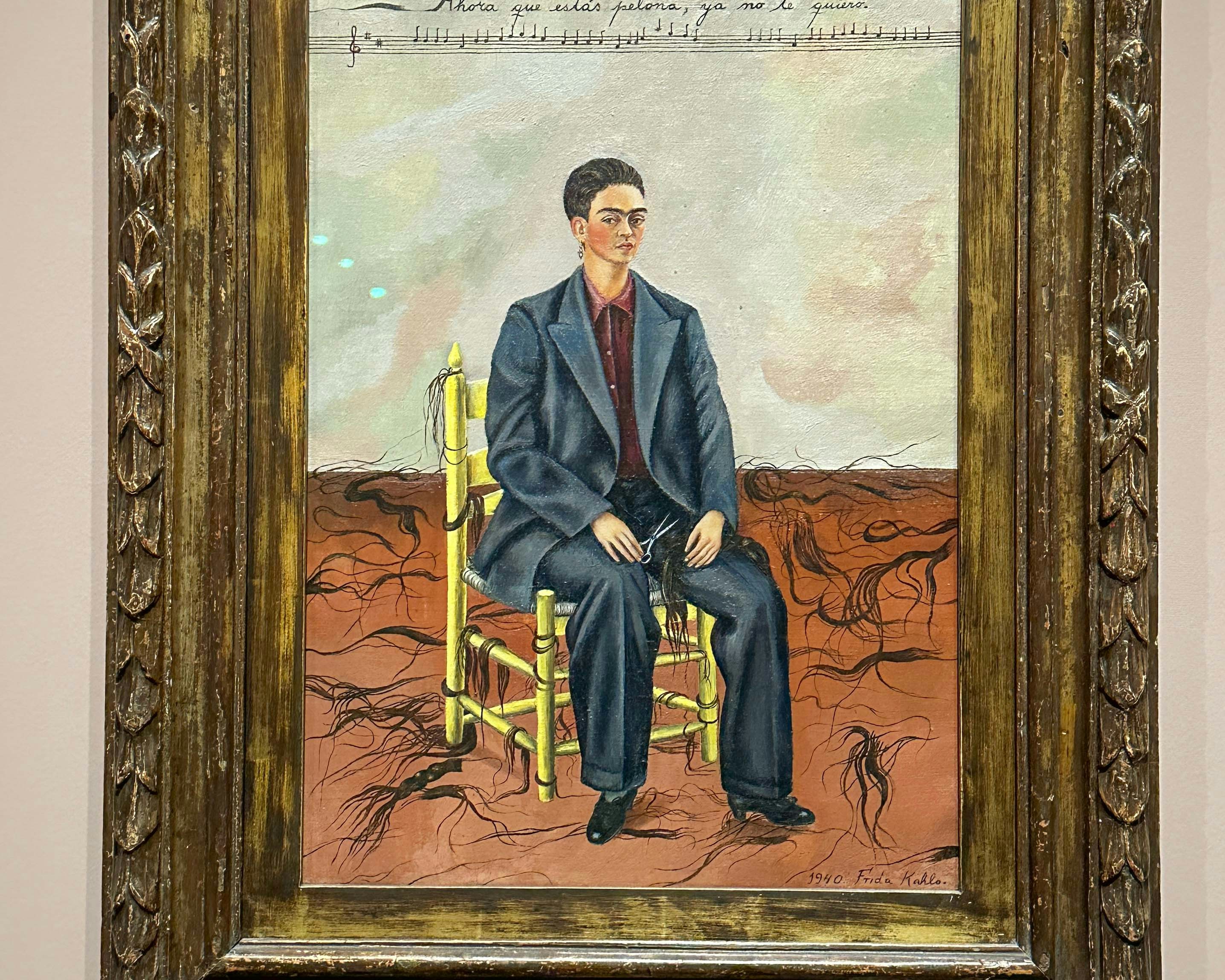 Frida Kahlo's "Self-Portrait with Cropped Hair" at MoMA exhibit, New York City.