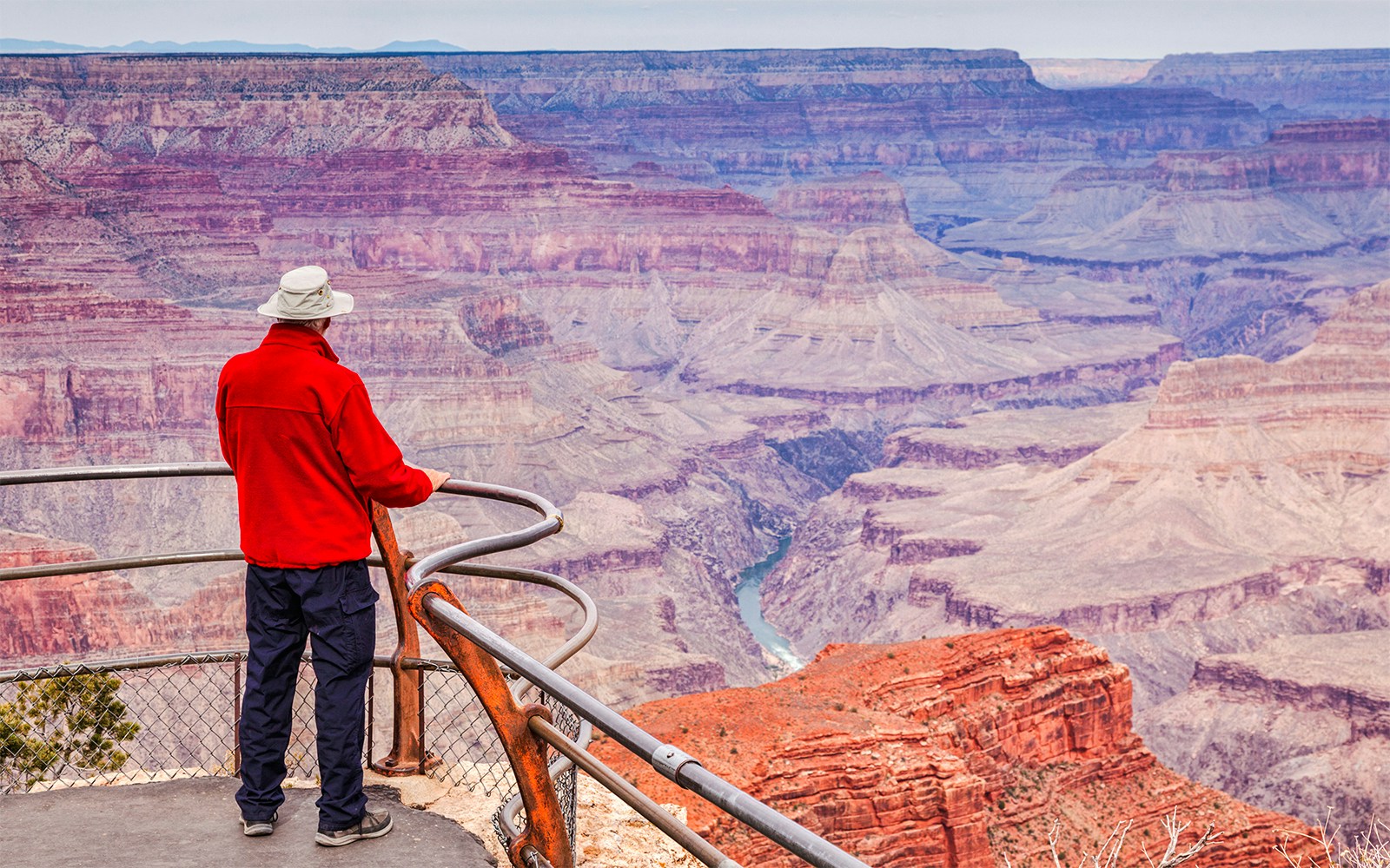 Man gazing over Hopi Point, Grand Canyon, capturing expansive canyon views.