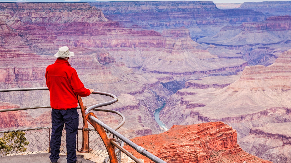 Man viewing Grand Canyon from Hopi Point overlook.