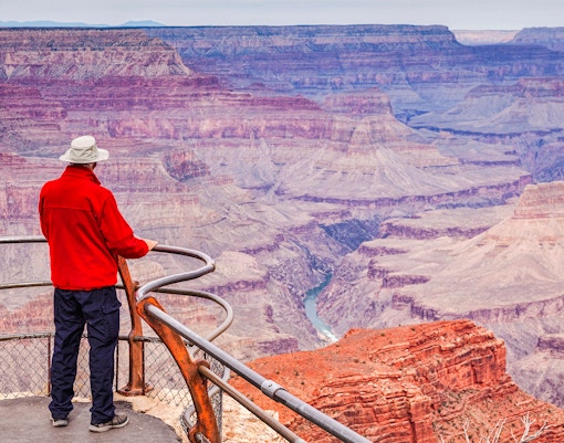 Man gazing over Hopi Point, Grand Canyon, capturing expansive canyon views.