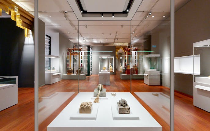 Exhibit of artifacts in Hong Kong Palace Museum gallery.