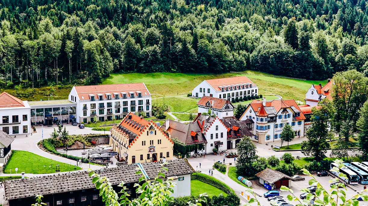 Village near Neuschwanstein Castle surrounded by forest, part of the summer tour from Munich with bike ride.