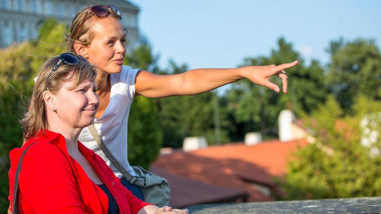 woman showing directions to tourist