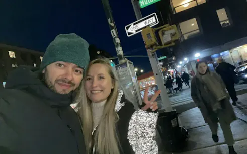 Couple on Lower East Side street at night, New York, during Mafia Mystery self-guided game.