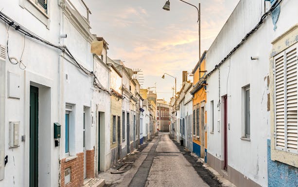 Narrow street with colorful houses on an island, part of a private half-day tour.
