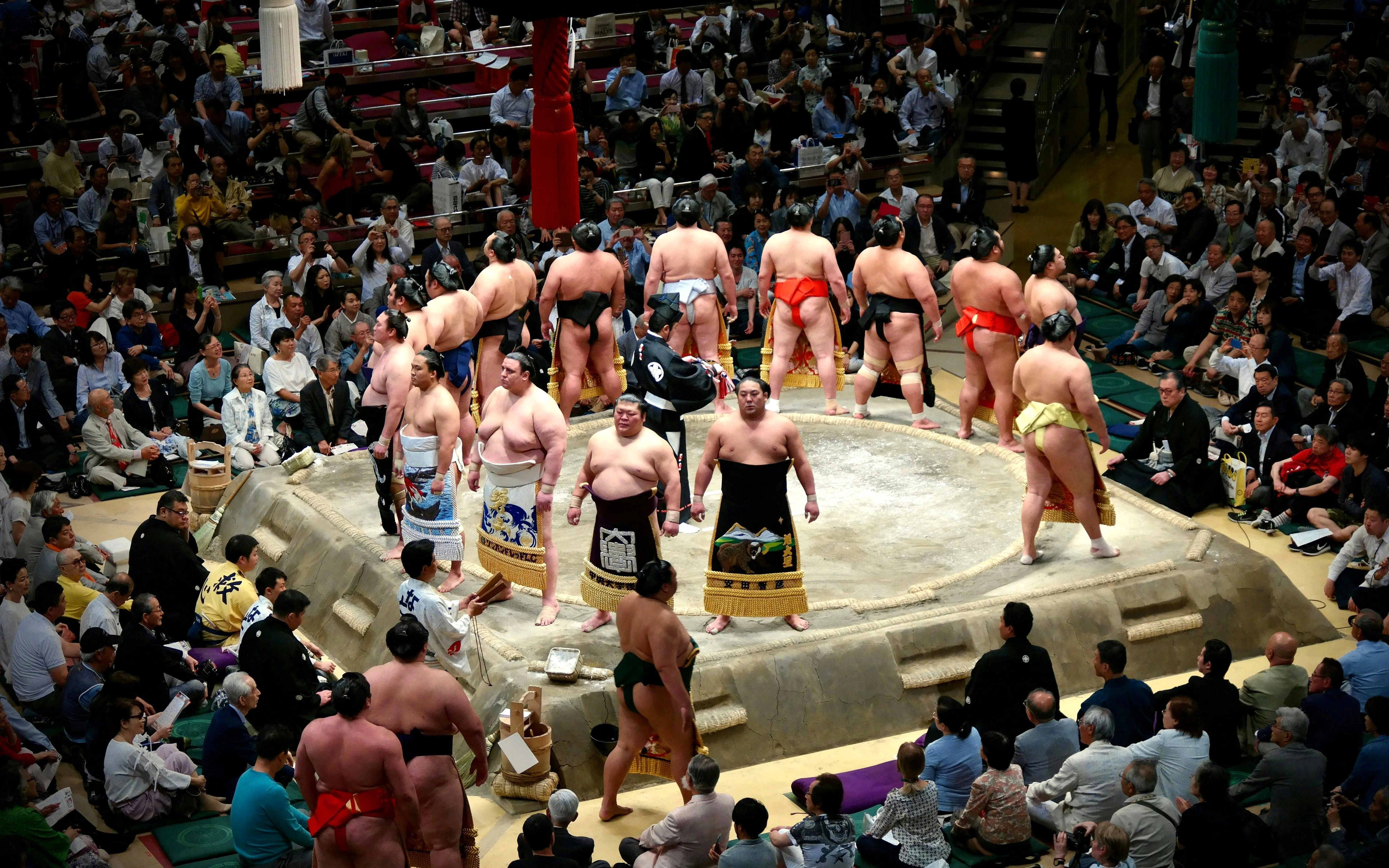 Sumo wrestlers in a ring during the Tokyo Grand Sumo Tournament in Sumida, Tokyo.