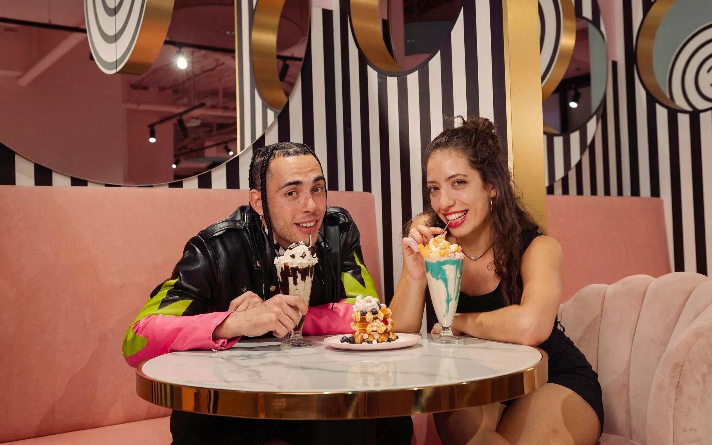 Guests enjoying milkshakes and snacks at Upside Down Berlin.