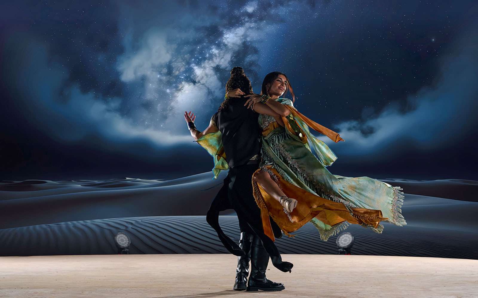 Dancers performing under starry sky at Noble Camp Desert Safari.
