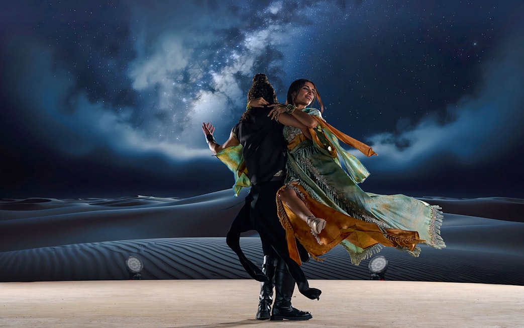 Dancers performing under starry sky at Noble Camp Desert Safari.
