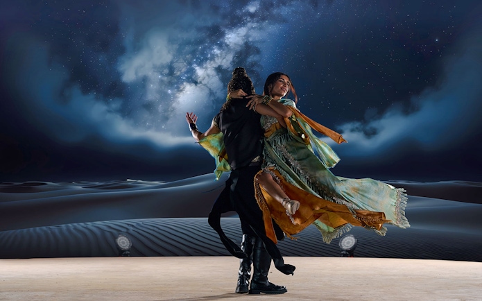 Dancers performing under starry sky at Noble Camp Desert Safari.