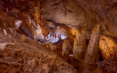 Visitors exploring stalactites and stalagmites in Jewel Cave, Margaret River guided tour.