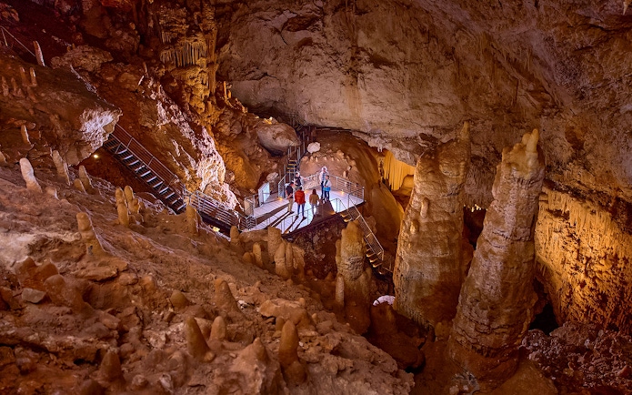 Visitors exploring stalactites and stalagmites in Jewel Cave, Margaret River guided tour.