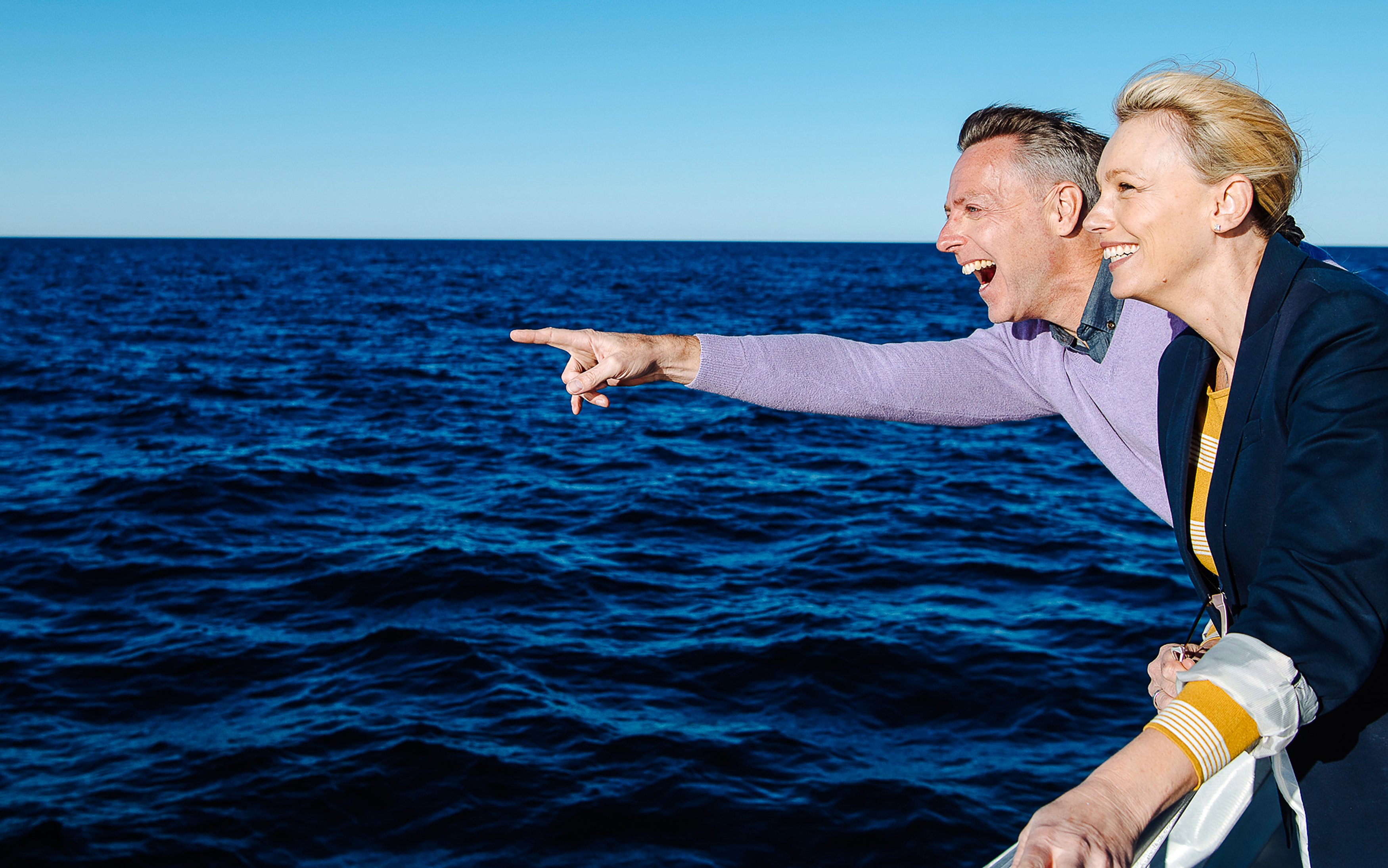 Couple enjoying ocean view on Vivid Sydney Sunset Cruise.