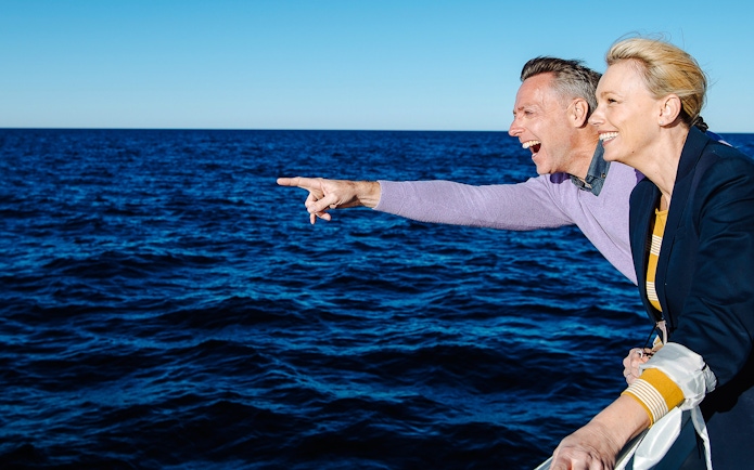 Couple enjoying ocean view on Vivid Sydney Sunset Cruise.