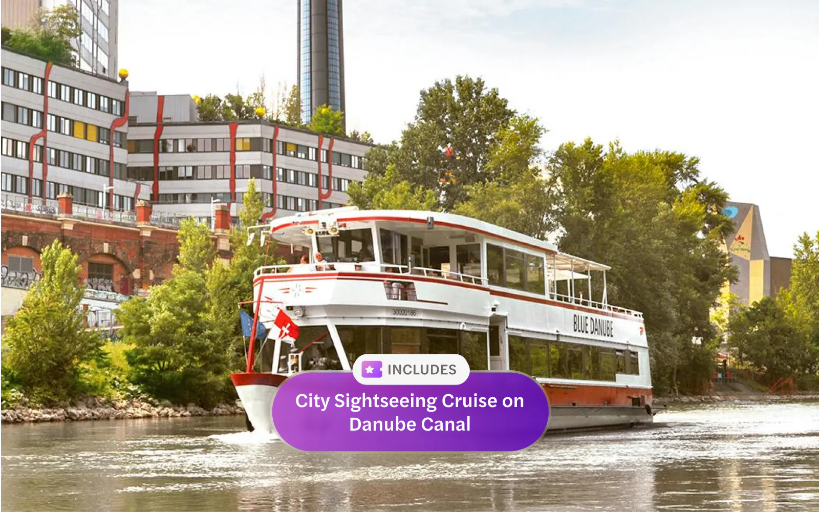 Sightseeing cruise boat on Danube Canal near Spittelau incinerator, Vienna.