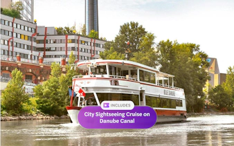 Sightseeing cruise boat on Danube Canal near Spittelau incinerator, Vienna.