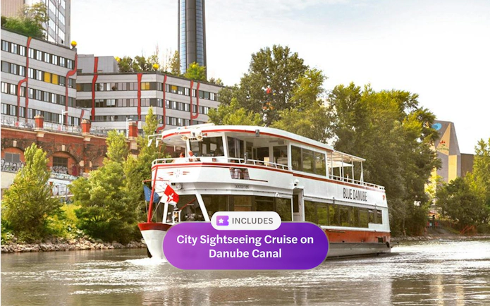 Sightseeing cruise boat on Danube Canal near Spittelau incinerator, Vienna.
