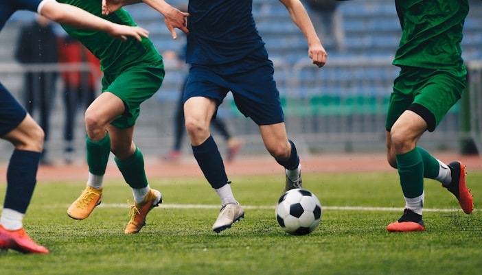 Football players tackling for the ball