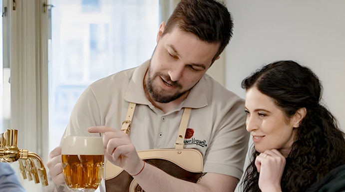 Bartender explaining Czech beer pouring technique to a visitor.