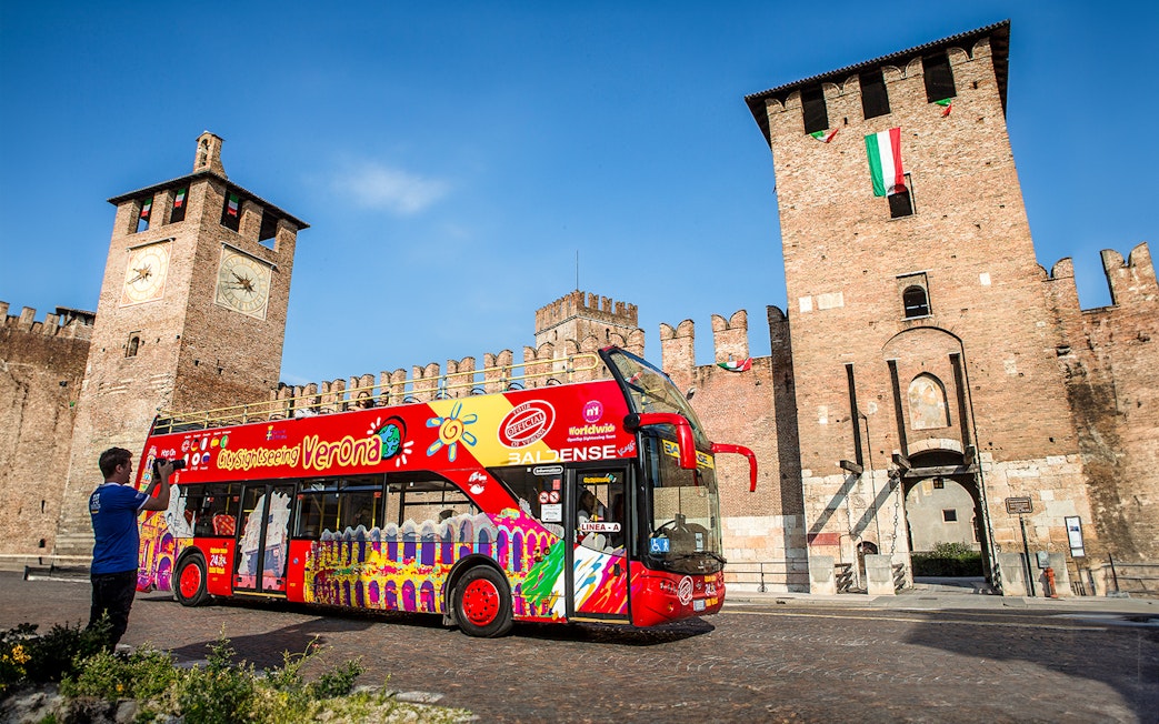 Verona sightseeing bus in front of Castelvecchio, Italy.