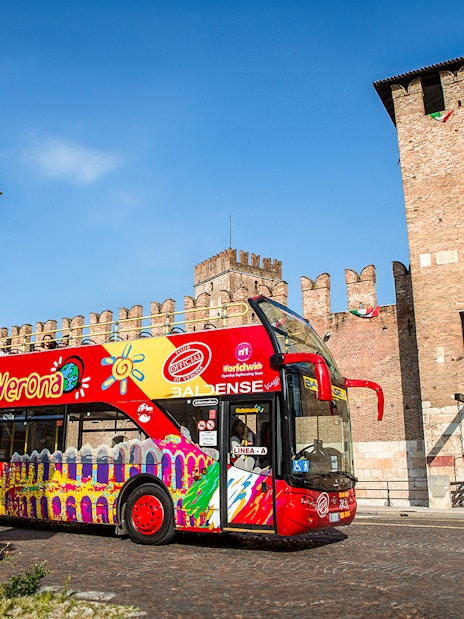 Verona sightseeing bus in front of Castelvecchio, Italy.