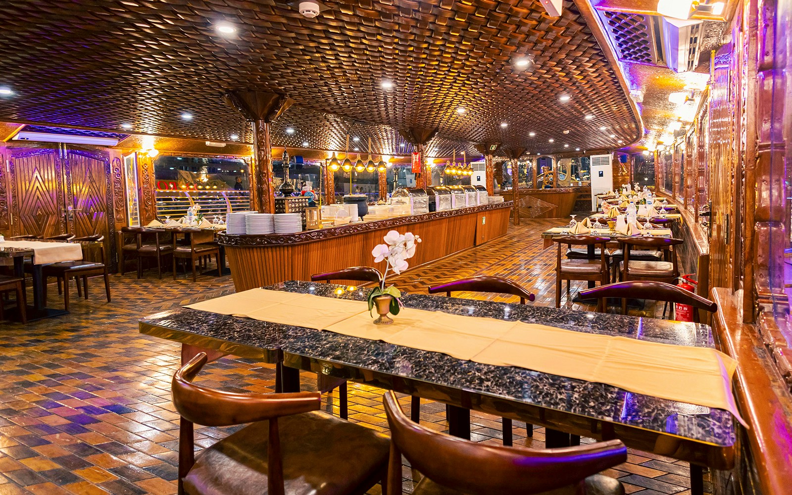 Alexandra Dhow Cruise with dinner and live entertainment at Dubai Marina, showcasing illuminated skyline views.
