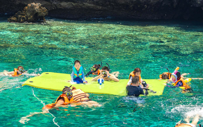 Snorkelers enjoying clear waters on Phi Phi Islands tour, Phuket.