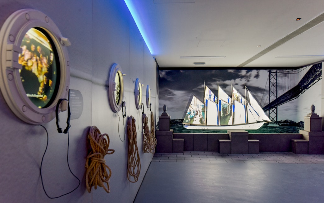 White fleet exhibit at Codfish History Interpretation Centre with ship projection and portholes.