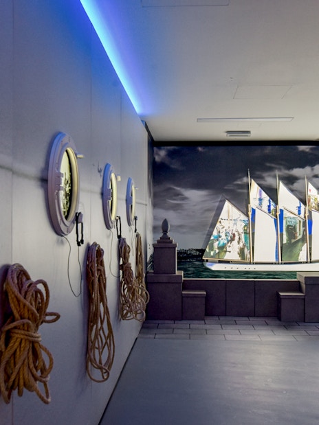 White fleet exhibit at Codfish History Interpretation Centre with ship projection and portholes.