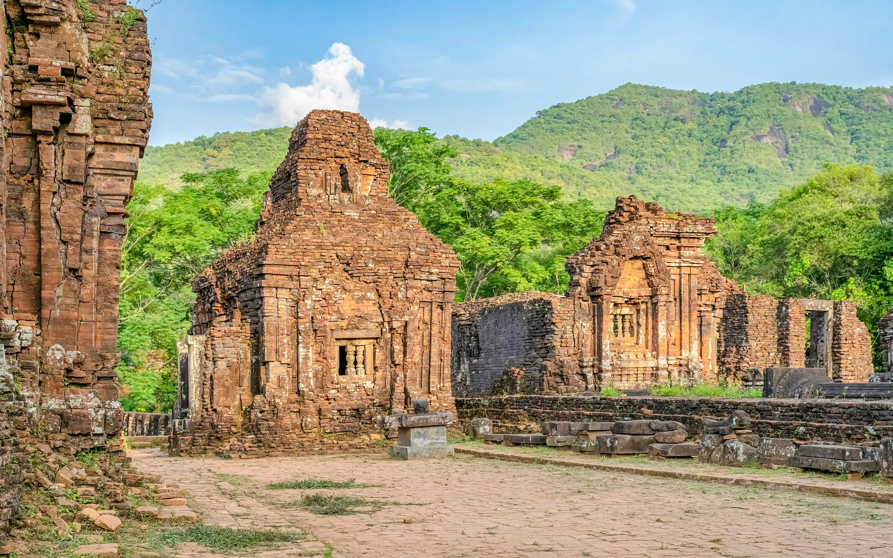 My Son Sanctuary ancient Cham temples in Quang Nam, Vietnam, surrounded by lush greenery.
