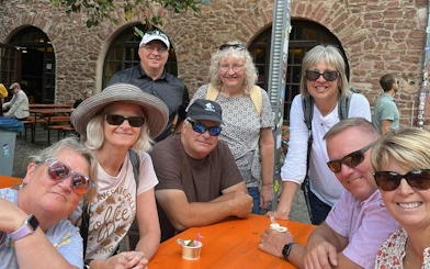 Group enjoying outdoor seating in Heidelberg during self-guided city exploration game.