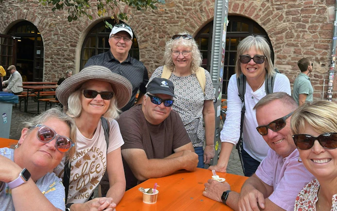 Group enjoying outdoor seating in Heidelberg during self-guided city exploration game.