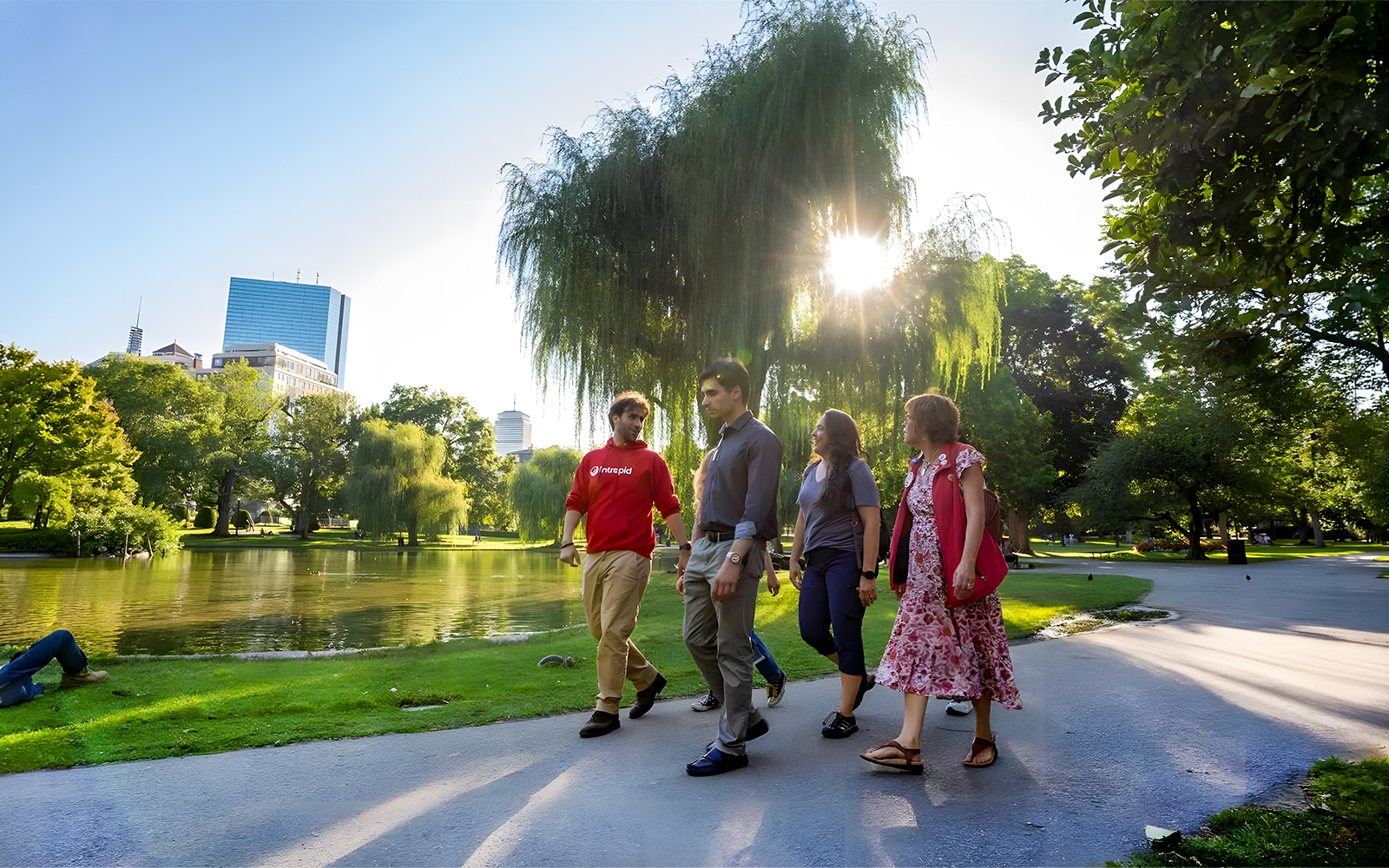 Tourists walking with guide in Boston Public Garden on History & Highlights Discovery Tour.