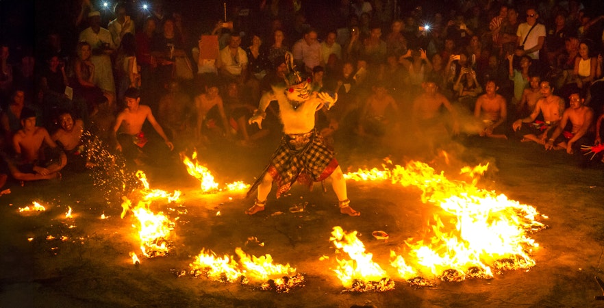 Uluwatu Kecak Fire Dance performance at sunset in Bali, Indonesia.