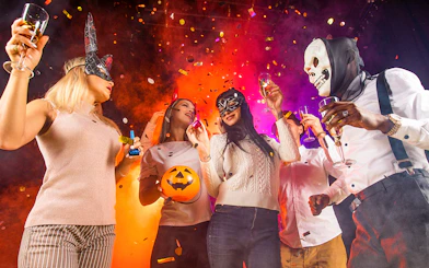 Partygoers in costumes celebrating at Bran Dracula's Castle Halloween event.