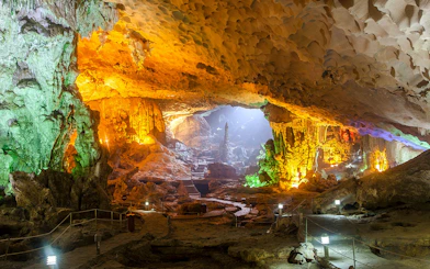 Sung Sot Cave interior with illuminated stalactites and stalagmites, Halong Bay, Vietnam.