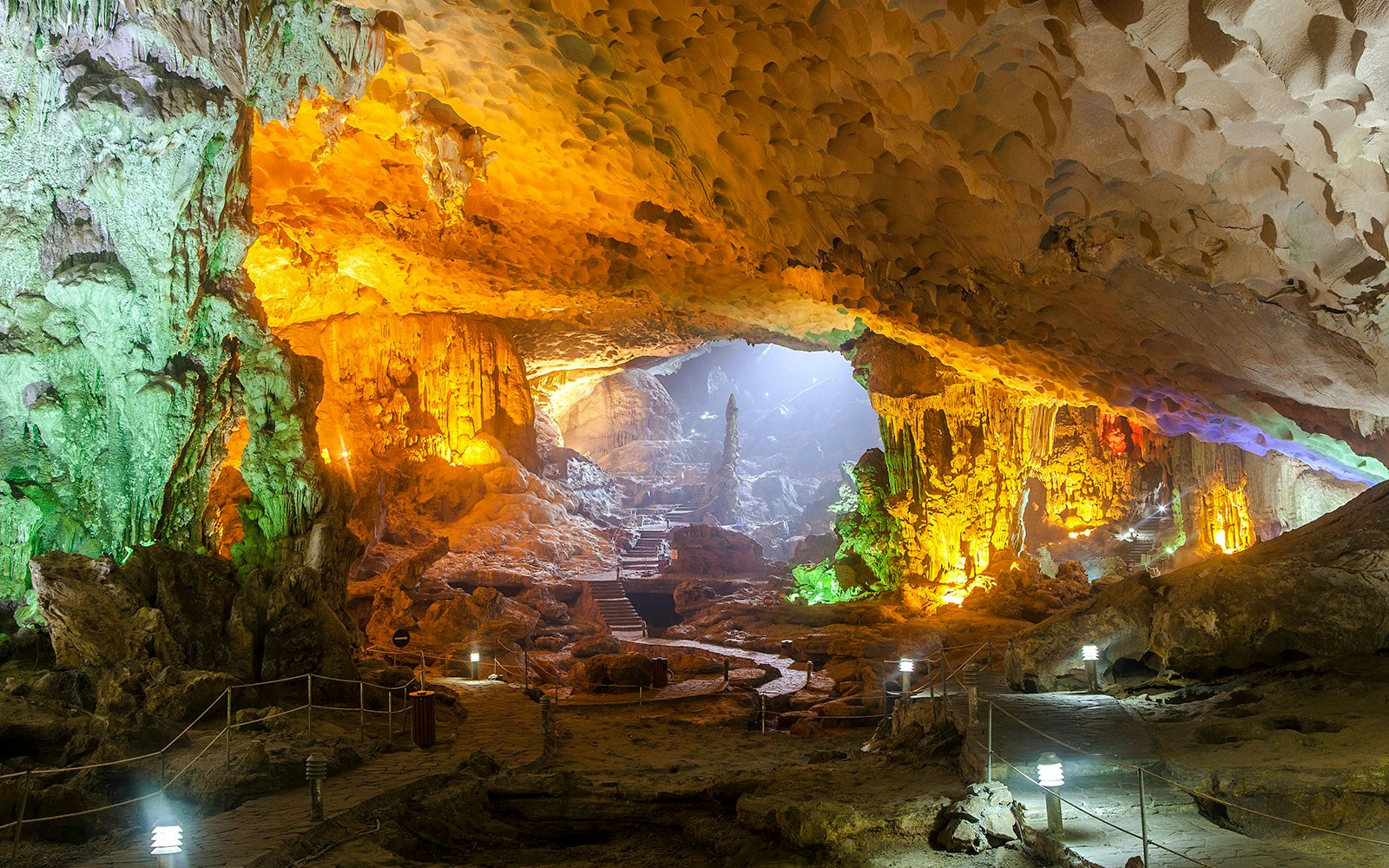 Sung Sot Cave interior with illuminated stalactites and stalagmites, Halong Bay, Vietnam.