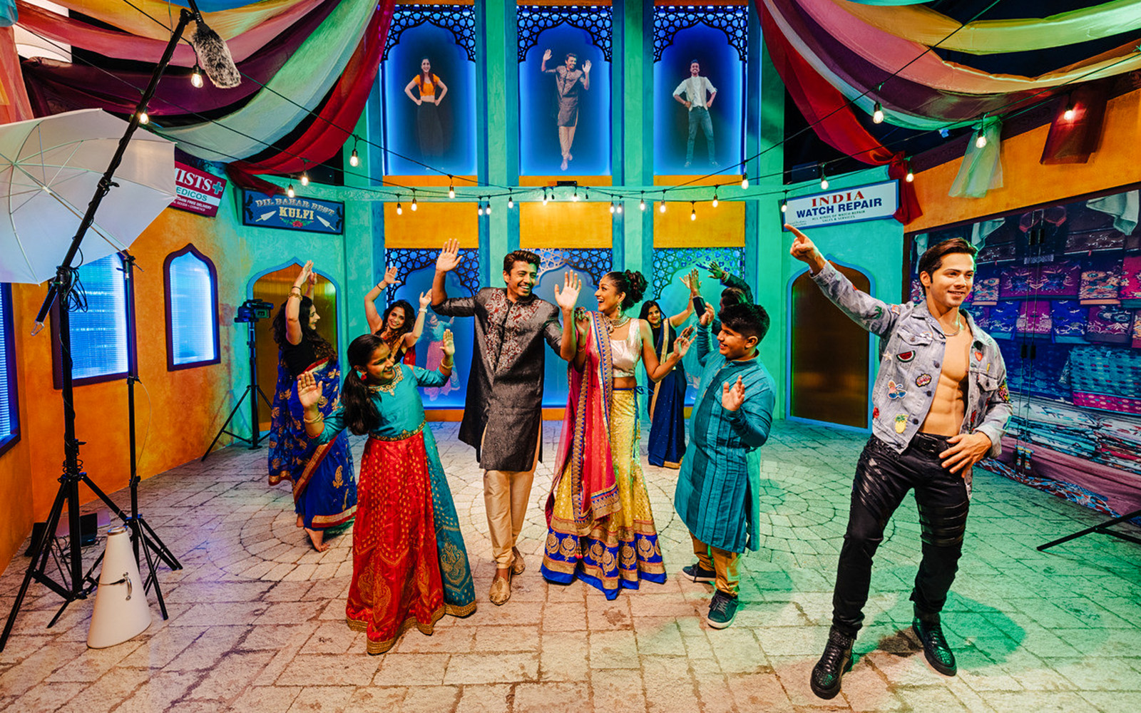Varun Dhawan wax figure with visitors dancing at Madame Tussauds Singapore.