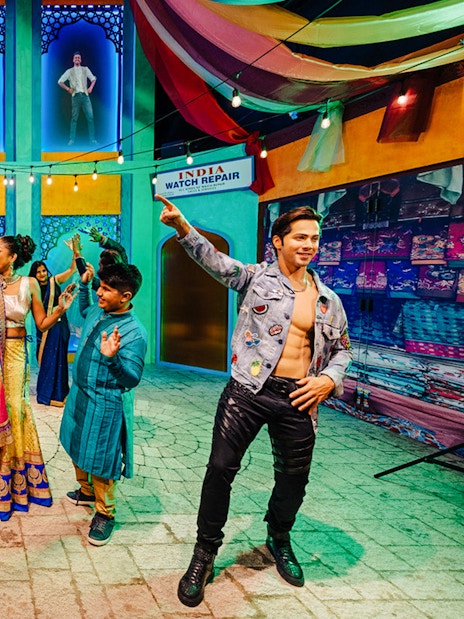 Varun Dhawan wax figure with visitors dancing at Madame Tussauds Singapore.