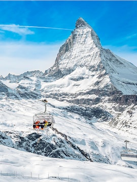 Ski lift ascending towards Matterhorn Glacier Paradise in the Swiss Alps.