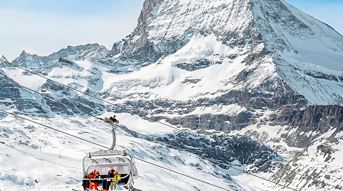 Ski lift ascending towards Matterhorn Glacier Paradise in the Swiss Alps.