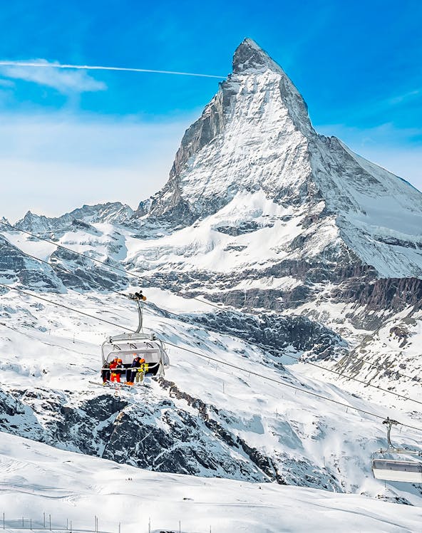 Ski lift ascending towards Matterhorn Glacier Paradise in the Swiss Alps.