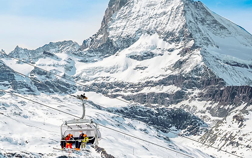 Ski lift ascending towards Matterhorn Glacier Paradise in the Swiss Alps.