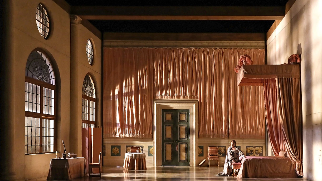 Opera stage set for "The Marriage of Figaro" with elegant drapery and period furniture.