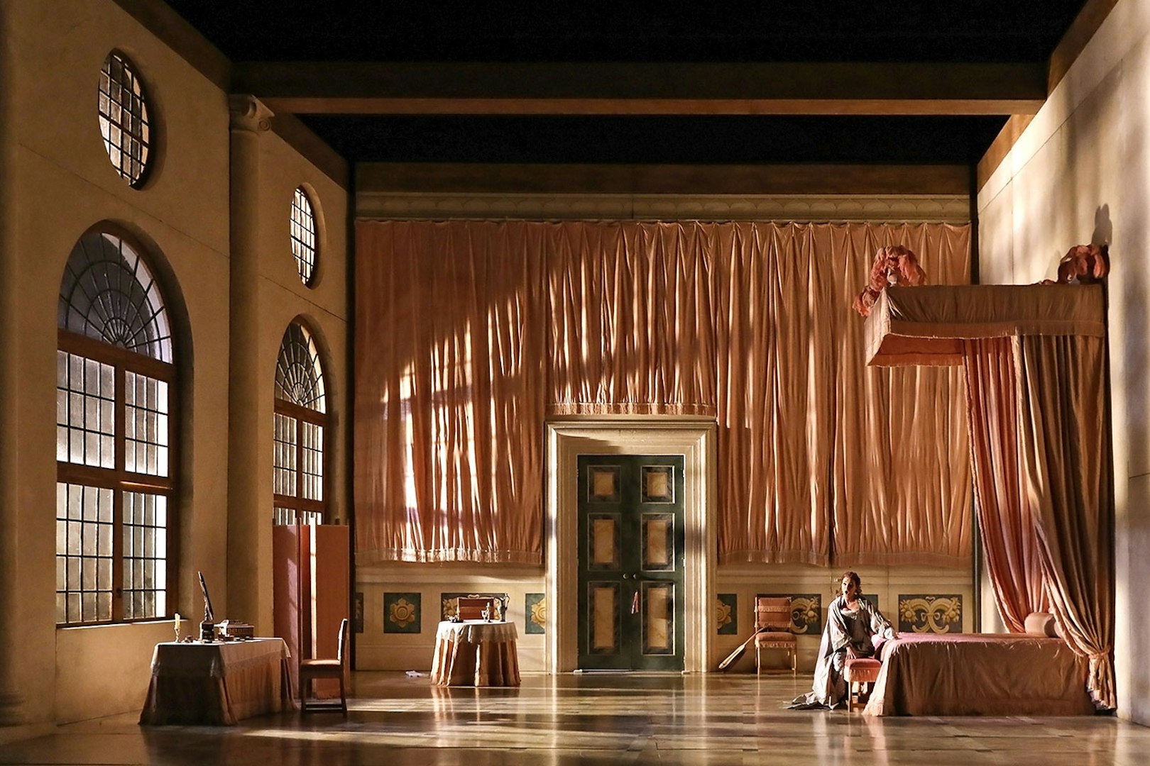 Opera stage set for "The Marriage of Figaro" with elegant drapery and period furniture.
