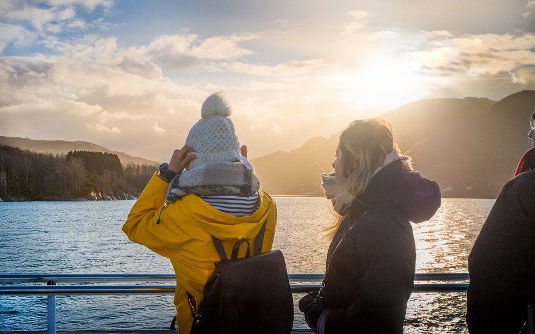 People enjoying scenic views on deck during Mostraumen Fjord Cruise.